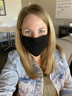 Karen Rangler, principal at YAP, smiles while wearing a mask 