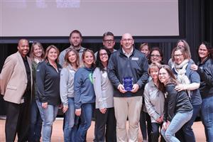 Principal Clint Wagner with his award and staff