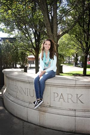 Lily Hall poses for a picture in the park 