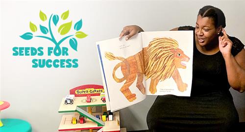 A woman reads a book at playgroup