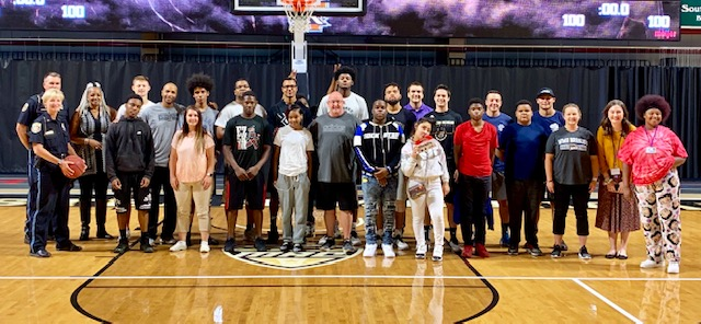 Youth post with YOU staff and Kalamazoo Public Safety officers while visiting WMU.