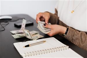 Person handling money, doing book work