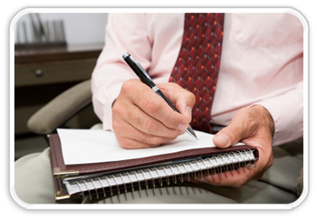 Photo of man writing on notepad